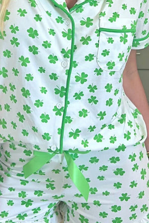 Green shamrock print silk pajama set with white and green trim.