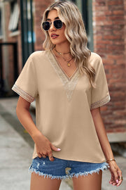 Cream lace trim V-neck short sleeve blouse with crochet detail on neckline and sleeves.