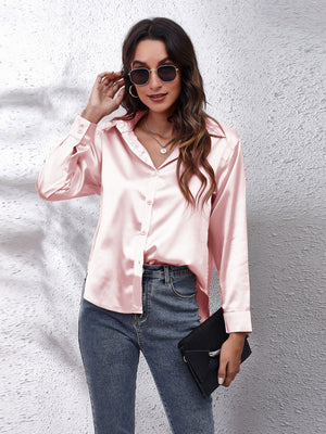 Blush pink silken button-down shirt with a relaxed fit and collared neckline.