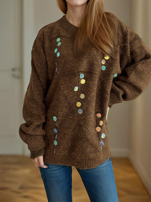 Brown knit sweater with scattered round sequins in iridescent colors.