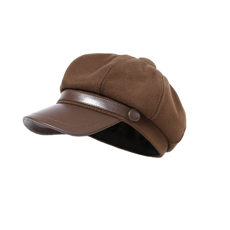 Classic newsboy cap in coffee brown with faux-leather brim and button detail.