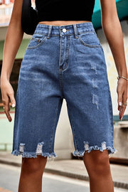 Medium wash denim bermuda shorts with frayed hem and distressed details.