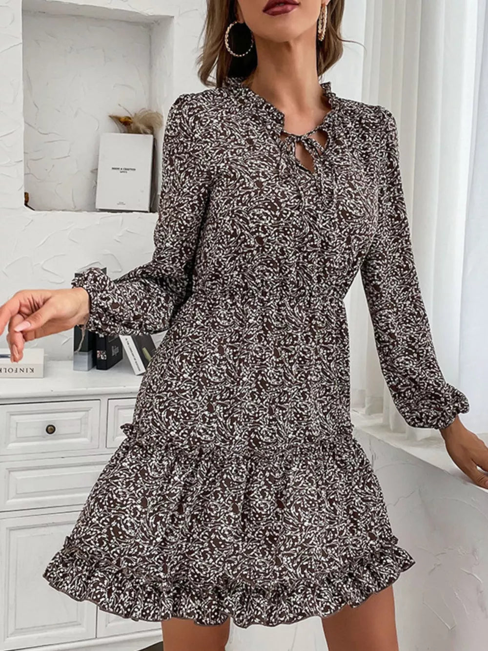 Dark brown floral mini dress with ruffled tie neck and tiered ruffled hem