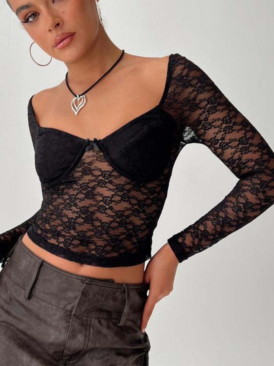 Black lace sweetheart bustier top with long sleeves and a bow detail.