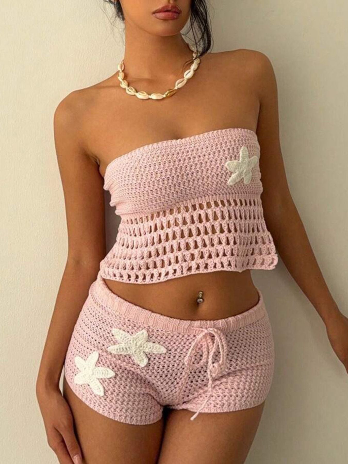 Pink crochet tube top and shorts set with starfish appliques and drawstring waist.