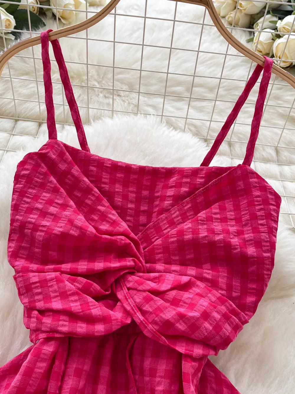 Rose red cami top with a twisted knot detail and checkered pattern.