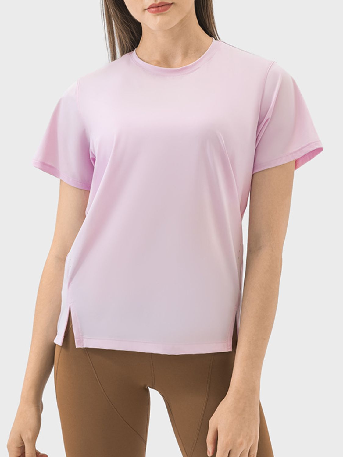 Blush pink performance t-shirt with short sleeves and side slits.