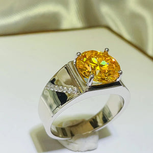 Radiant yellow moissanite and silver band ring with small accent diamonds on the band.