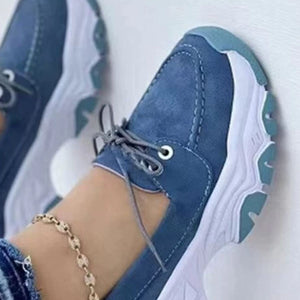 Blue suede lace-up sneakers with a chunky white and teal sole.