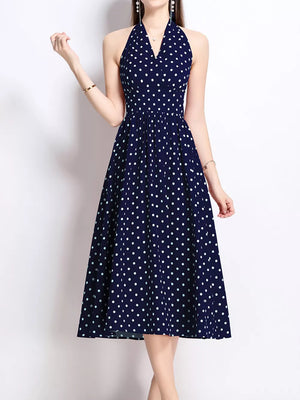 Navy polka dot halter midi dress with V-neck and flared skirt.