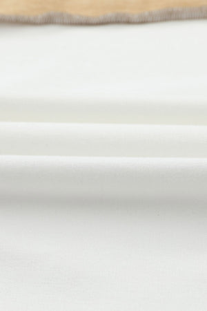 Colorblock knit top in tan and white with seam detail.