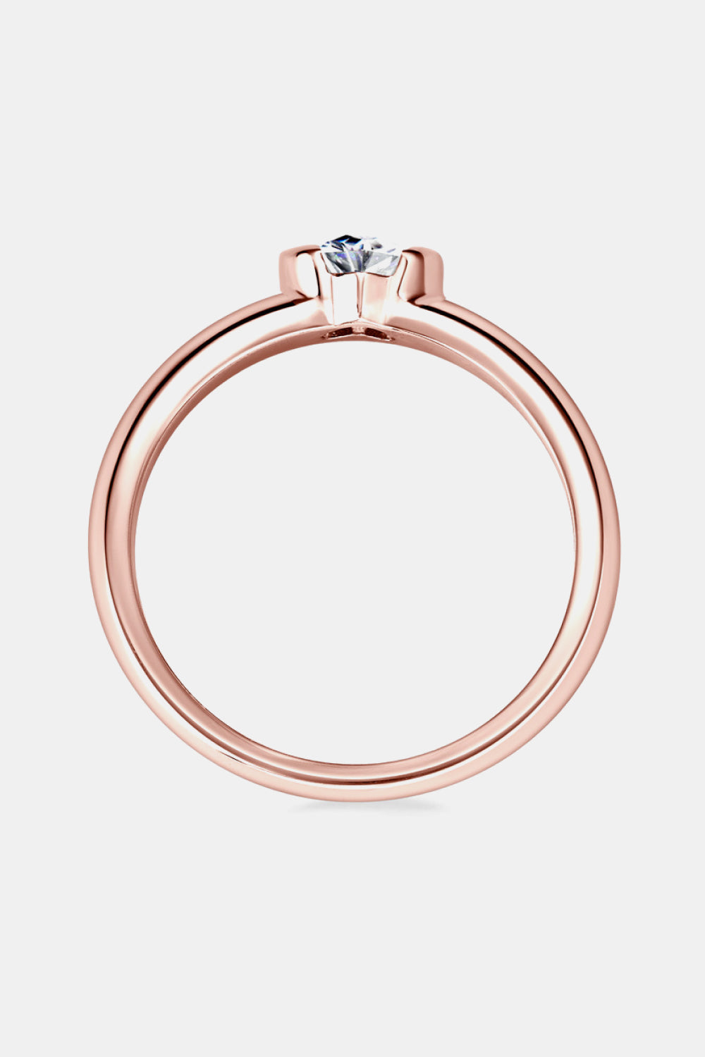 Rose gold band ring with a heart-cut moissanite solitaire.