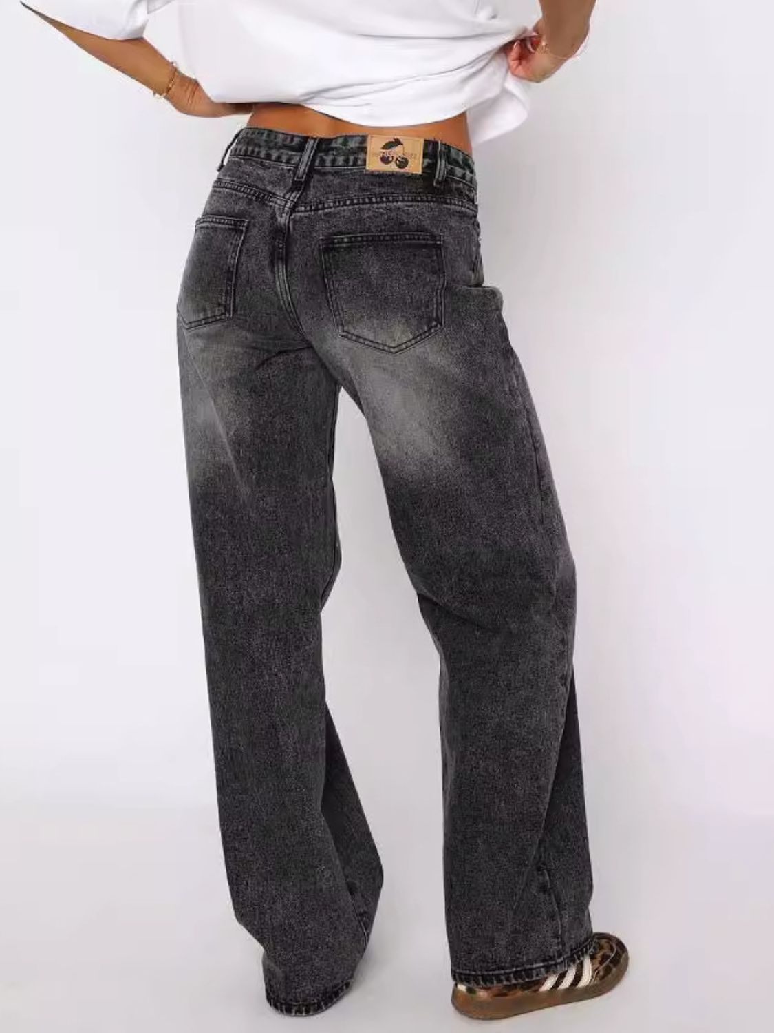 Dark gray wide-leg denim jeans with contrast stitching and a faded wash.