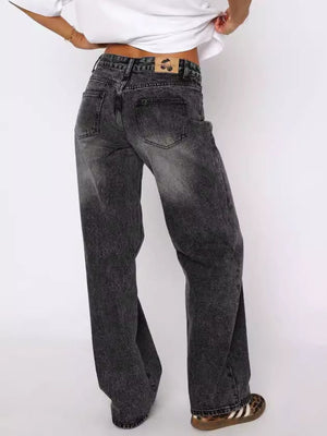 Dark gray wide-leg denim jeans with contrast stitching and a faded wash.