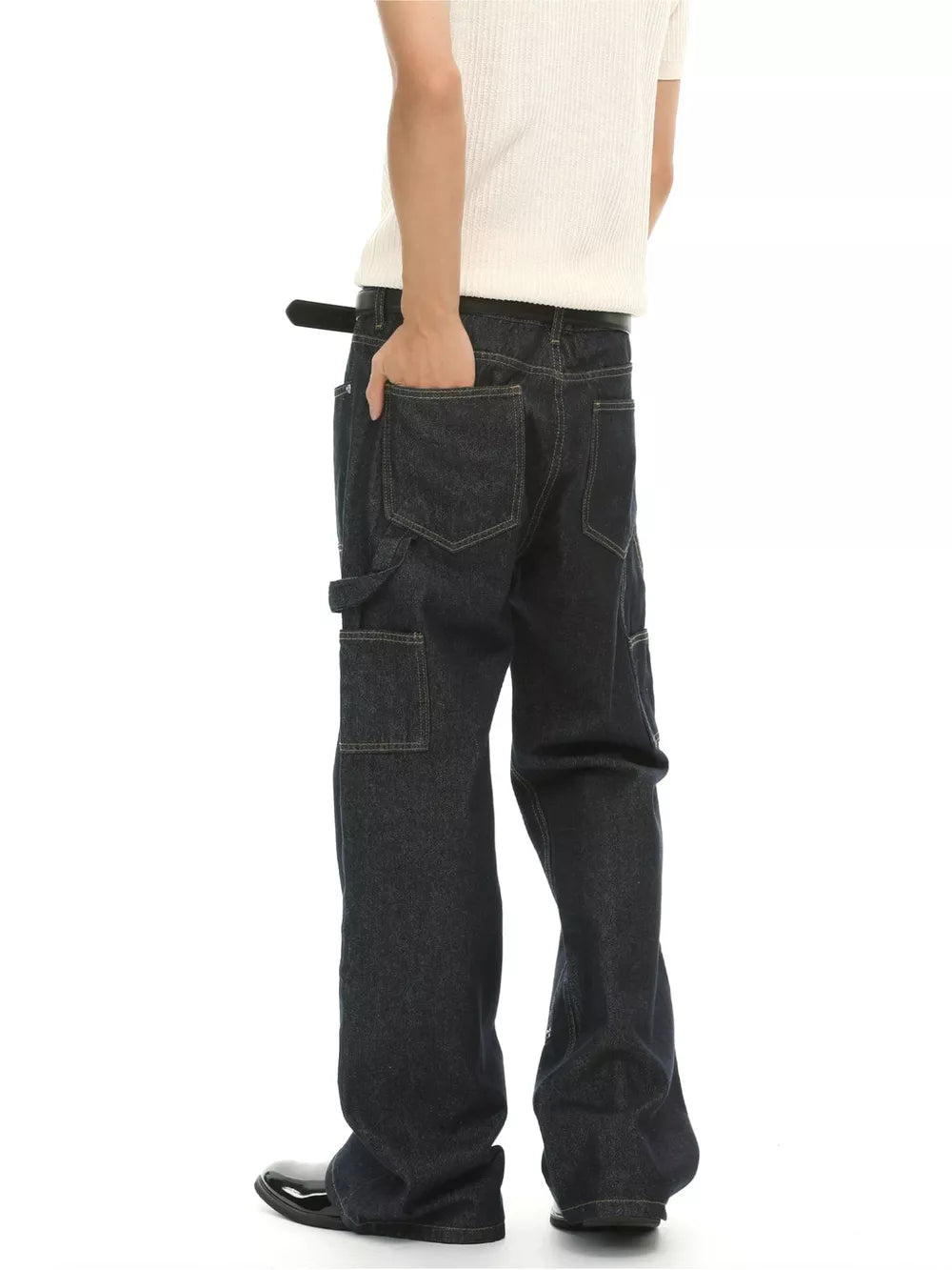 Dark wash cotton blend carpenter jeans with distinctive pockets and contrast stitching.