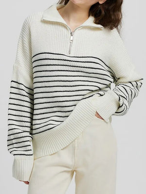 Ribbed stripe half-zip knit sweater in cream with black stripes and a quarter zip neckline.