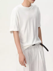 White cotton t-shirt with crew neck and cuffed short sleeves.
