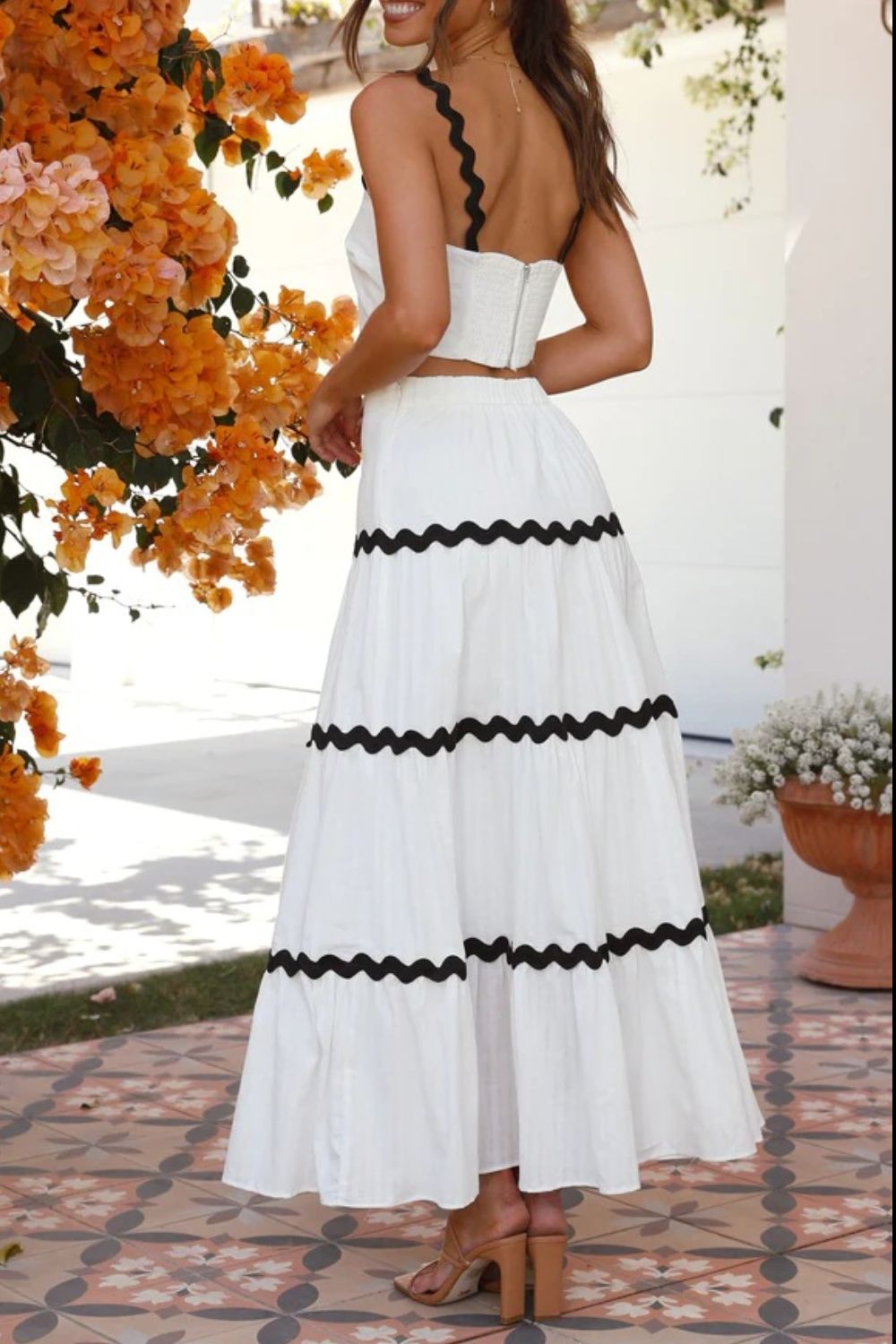 White crop top and tiered maxi skirt set with black scalloped trim detail.