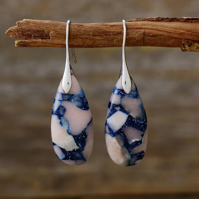 Marbled teardrop earrings with pink, white, and blue gemstone mosaic pattern and silver hooks.