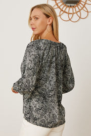 Black serpentine print blouse with gathered sleeves and a relaxed fit.
