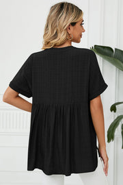 Black linen blouse with gathered back detail and short sleeves.