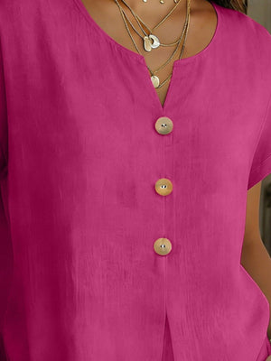 Buttoned short sleeve blouse in cerise with a V-neck and wooden buttons.
