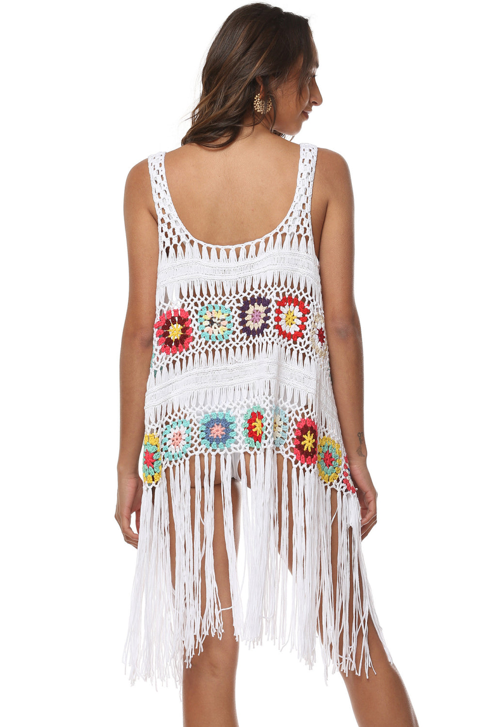 White crochet vest with colorful floral squares and fringe detail.