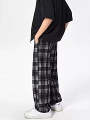 Plaid drawstring sweatpants in black and white with a relaxed fit.