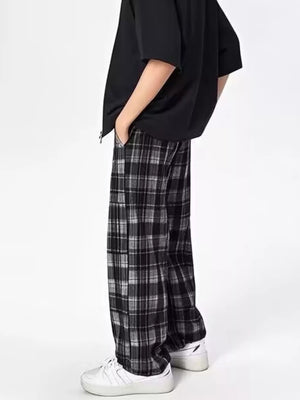 Plaid drawstring sweatpants in black and white with a relaxed fit.