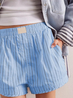 Light blue striped boxer shorts with elastic waistband and pockets.