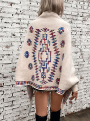 Cream Aztec fringe knit cardigan with colorful geometric pattern and fringe detail.