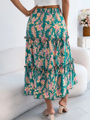 Green floral midi skirt with tiered ruffle hem and smocked waist.