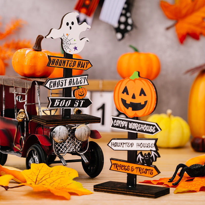 Halloween directional signposts with ghost and pumpkin decorations point to haunted places.