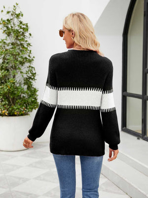 Black ribbed sweater with white horizontal stripe detail on sleeves and torso.