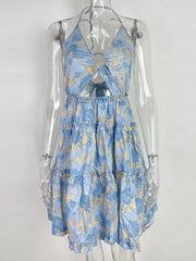 Pastel blue halter mini dress with abstract floral print, cutout, and tiered ruffles.