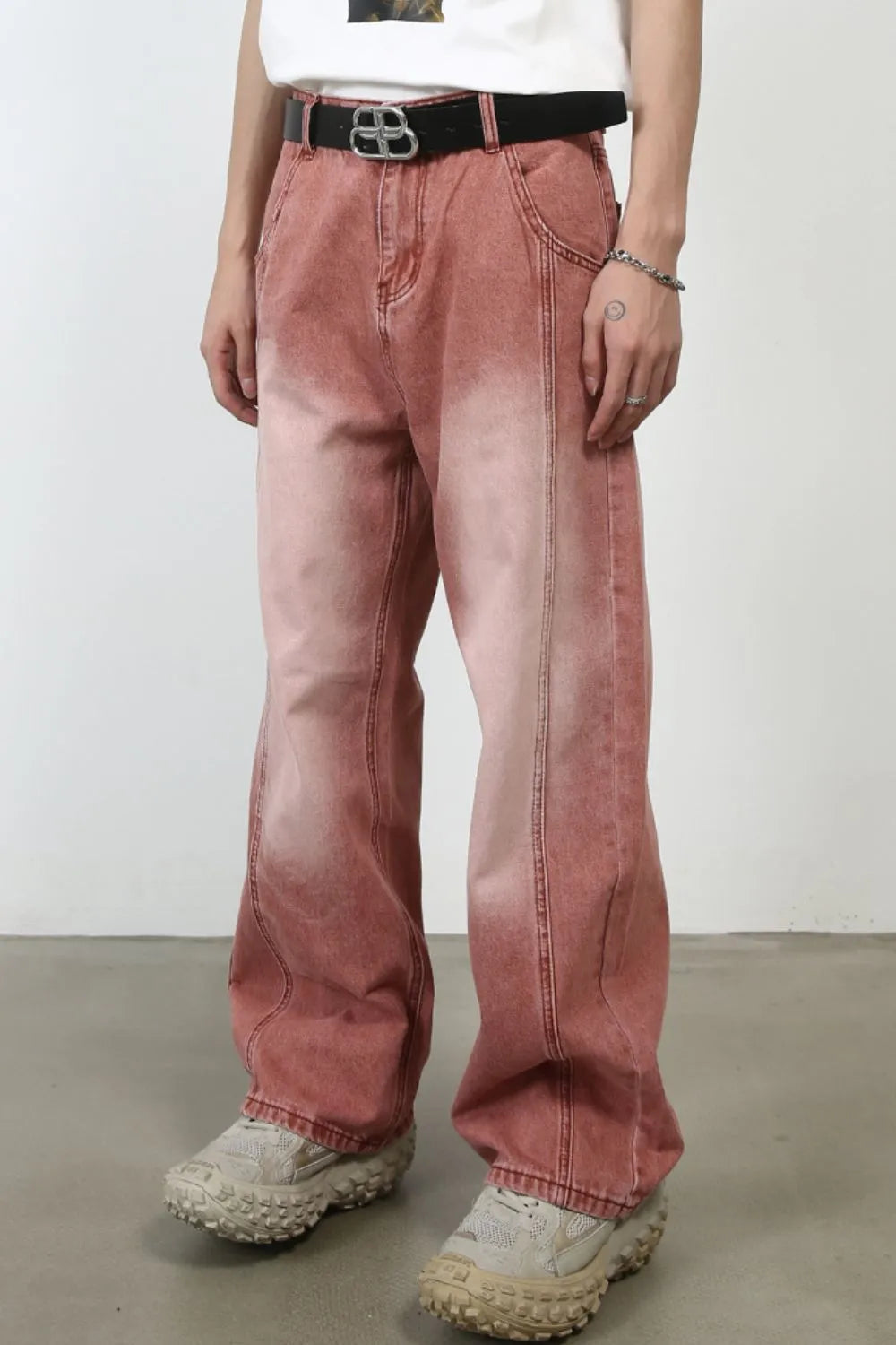 Relaxed fit coral denim jeans with a faded wash and front seam detail.