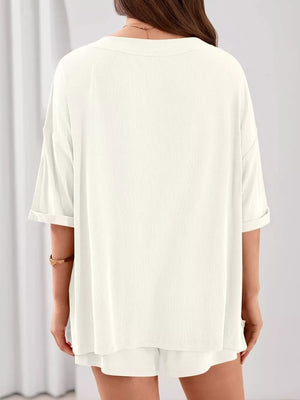Ivory ribbed V-neck two-piece lounge set with cuffed short sleeves and shorts.