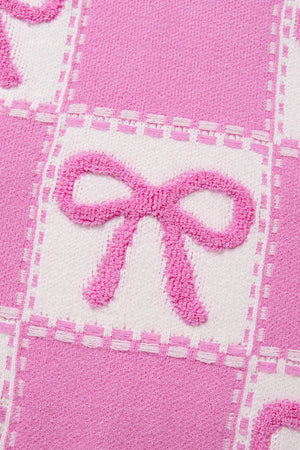 Fuchsia pink and white checkered knit sweater with textured bow details.