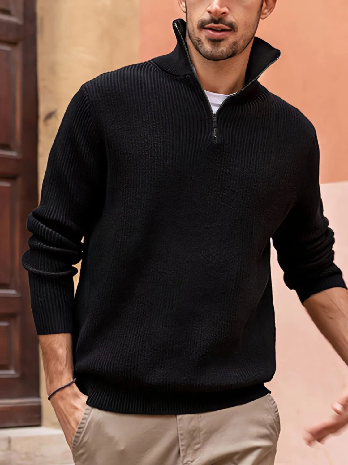 Black ribbed quarter-zip pullover sweater with a stand-up collar and zip detail.