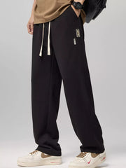 Relaxed fit black drawstring sweatpants with white laces and a small logo patch.