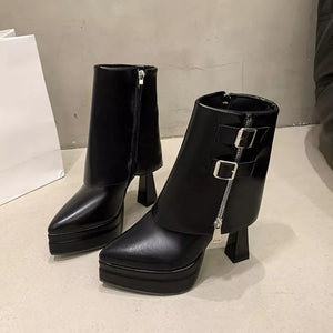 Black pointed toe ankle boots with block heel, platform sole, side zipper and buckle straps.
