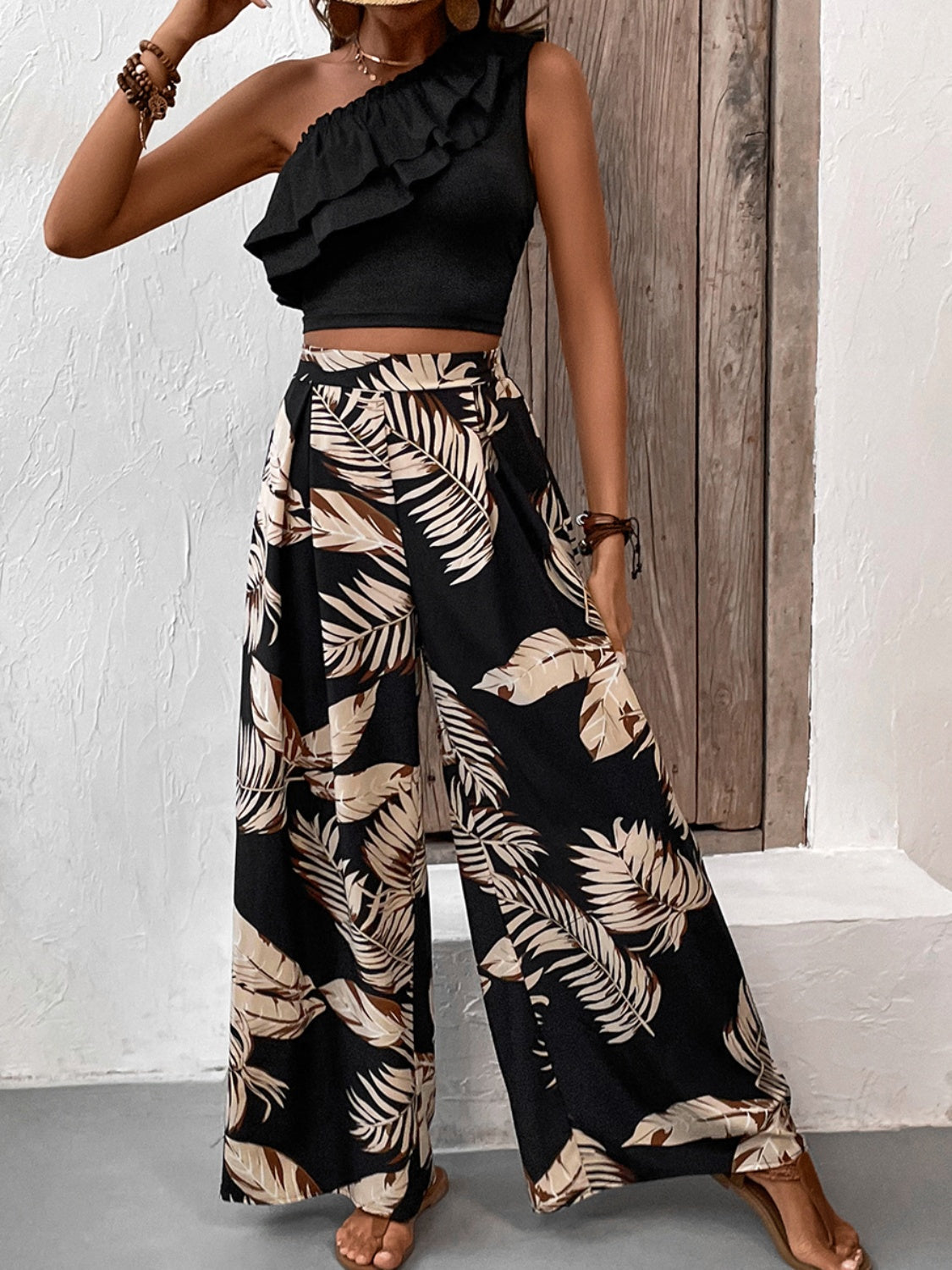 Black asymmetrical ruffle crop top and wide-leg palm print pants set