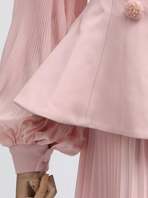Pink skirt suit with pleated balloon sleeves and a decorative floral collar detail.