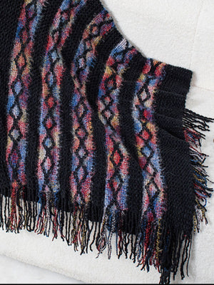 Black acrylic knit cape with colorful diamond pattern and fringe detail