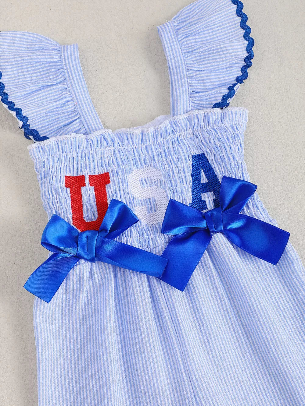 Children's Usa Themed Ruffled Sleeve Smocked Jumpsuit in Blue, model styling view