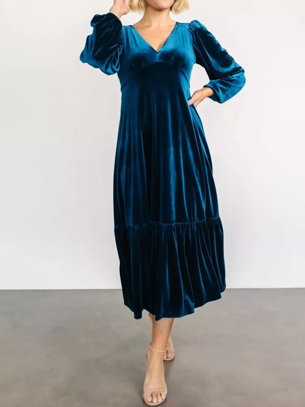 Peacock blue velvet midi dress with tiered skirt and puff sleeves.