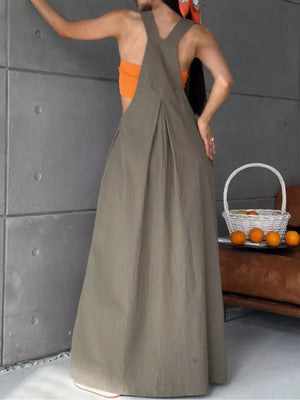 Army green pleated overall dress with V-neck and adjustable straps, full length skirt.