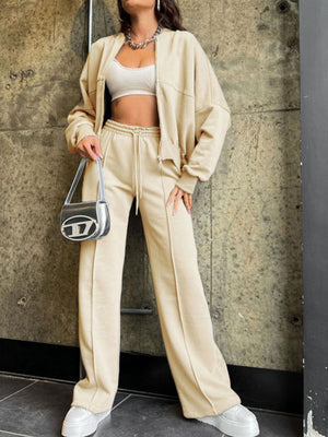 Tan zip-up hoodie and drawstring pants coord set with white crop top and silver bag.