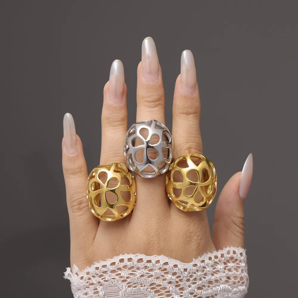 Openwork orb rings in gold and silver, featuring a hollow sphere design.