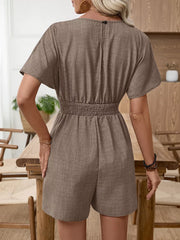 Camel V-neck romper with short sleeves and smocked waist detail.